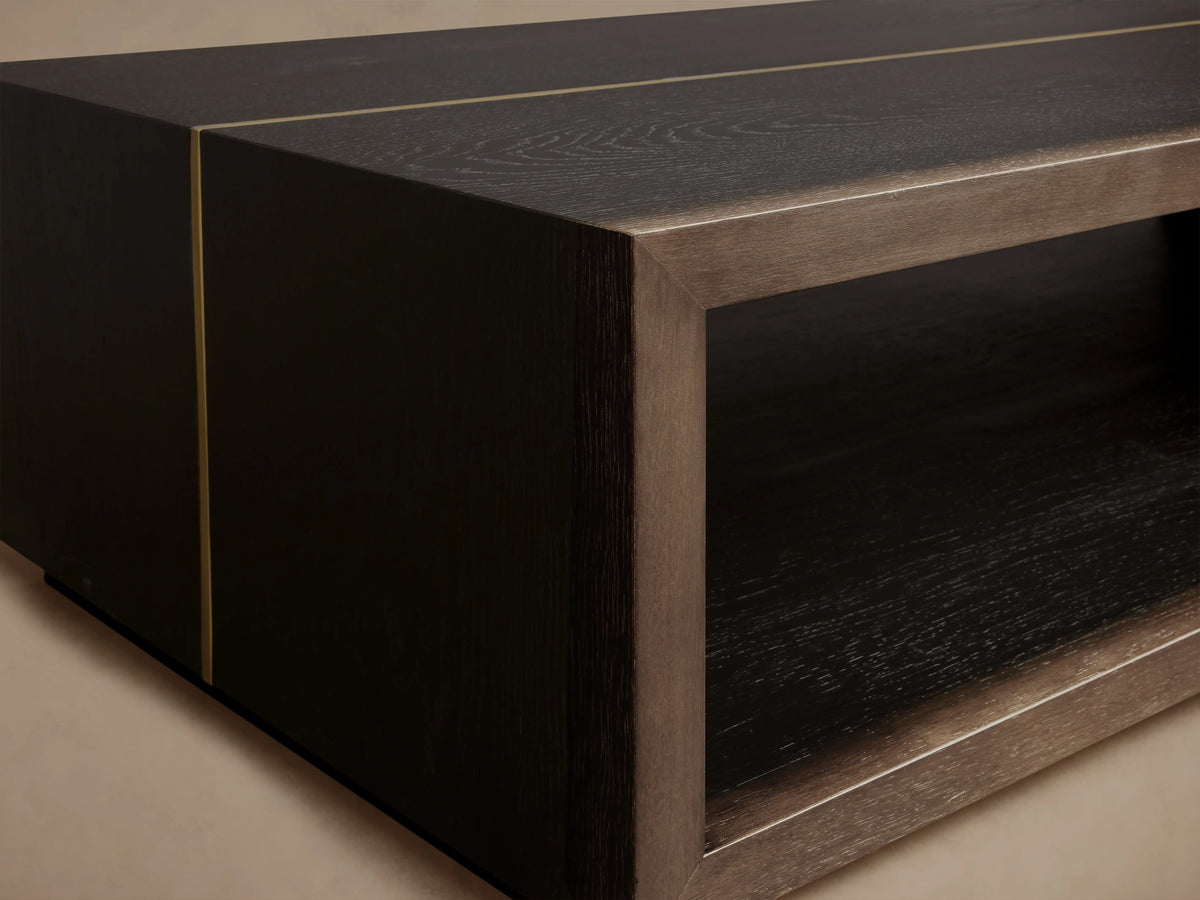 Mihaela Coffee Table with a dark wooden finish and metallic brass-like accents, showcasing a rectangular open compartment.