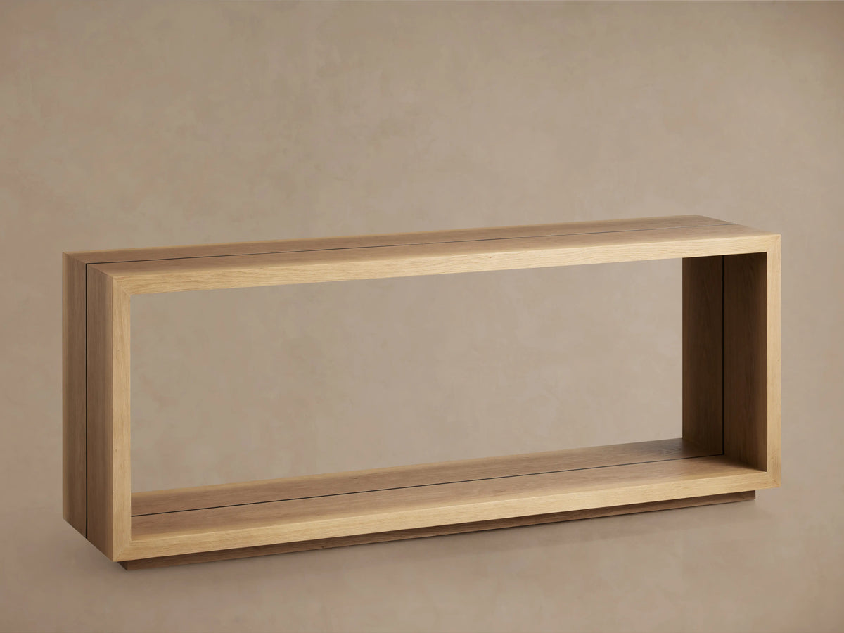 A wooden console table with a rectangular open frame made of Romanian oak and spruce layers, with a natural finish showcasing wood grain.