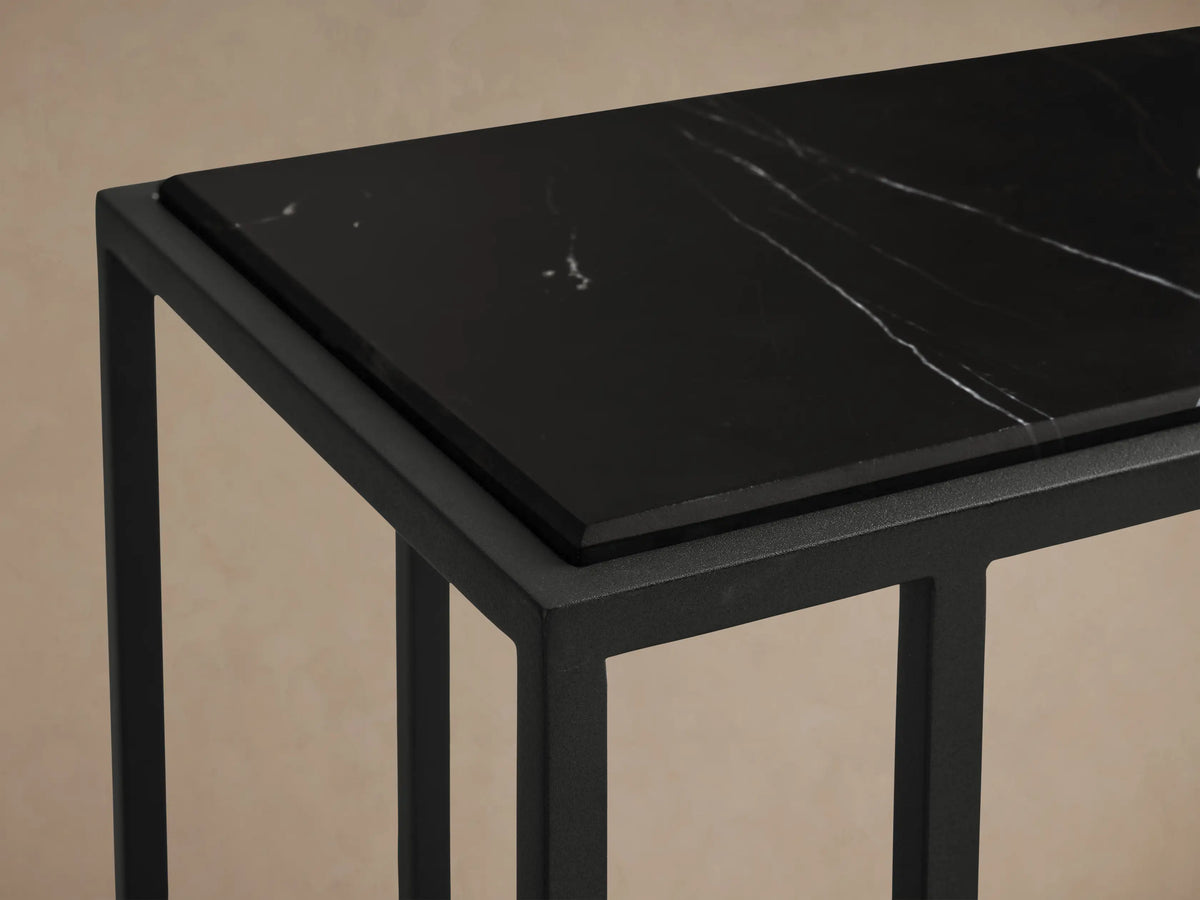 Mills Stone C Table: rectangular black stone top with white veins, supported by a matte black C-shaped metal base.