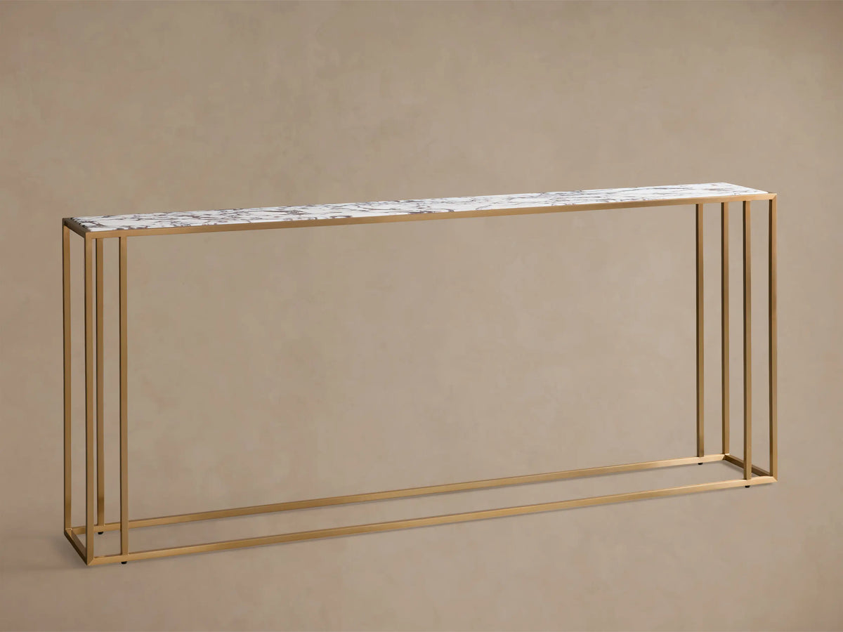 Front view of the white and gray veined Mills Stone Console Table with a long stone top and an antique brass metal frame.