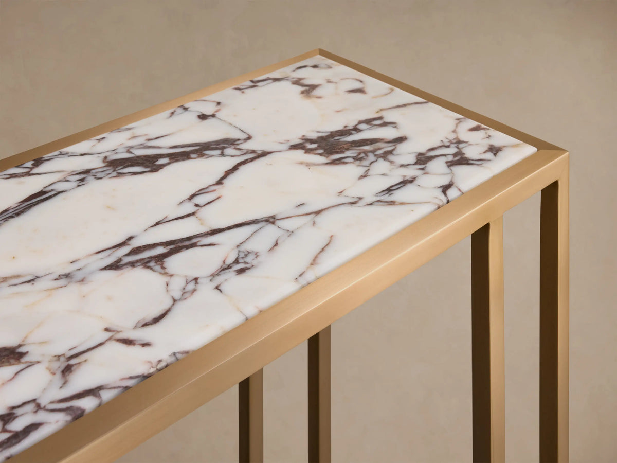 Close-up of the Mills Stone Console Table, showing its white stone top with brown veining and an antique brass frame.