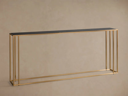 Close-up, angled view of the Mills Stone Console Table, featuring a black stone top with white veining and an antique brass frame.