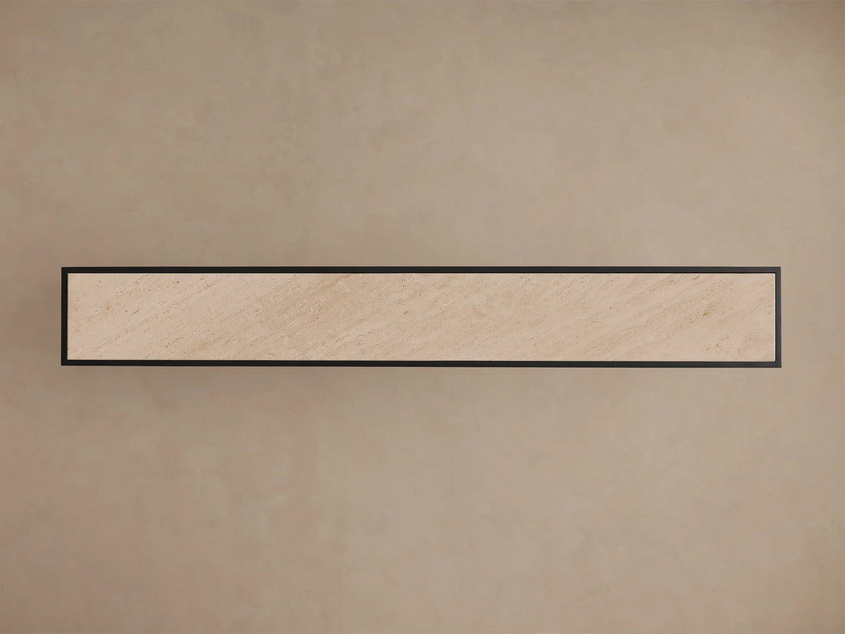 Top-down view of the Mills Stone Console Table, showing its light beige stone top with natural veining and matte black frame.