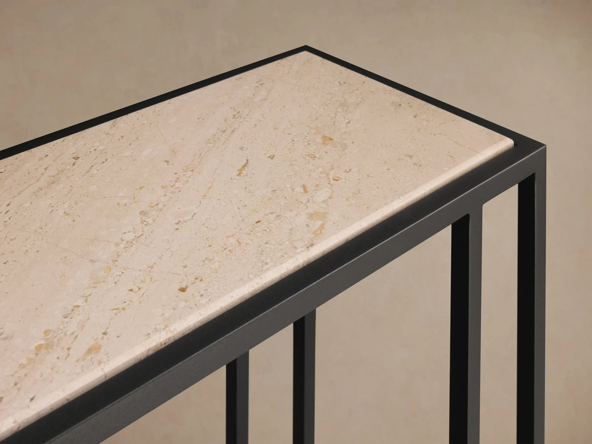 Front view of the long, rectangular Mills Stone Console Table with a light beige stone top and matte black steel frame.
