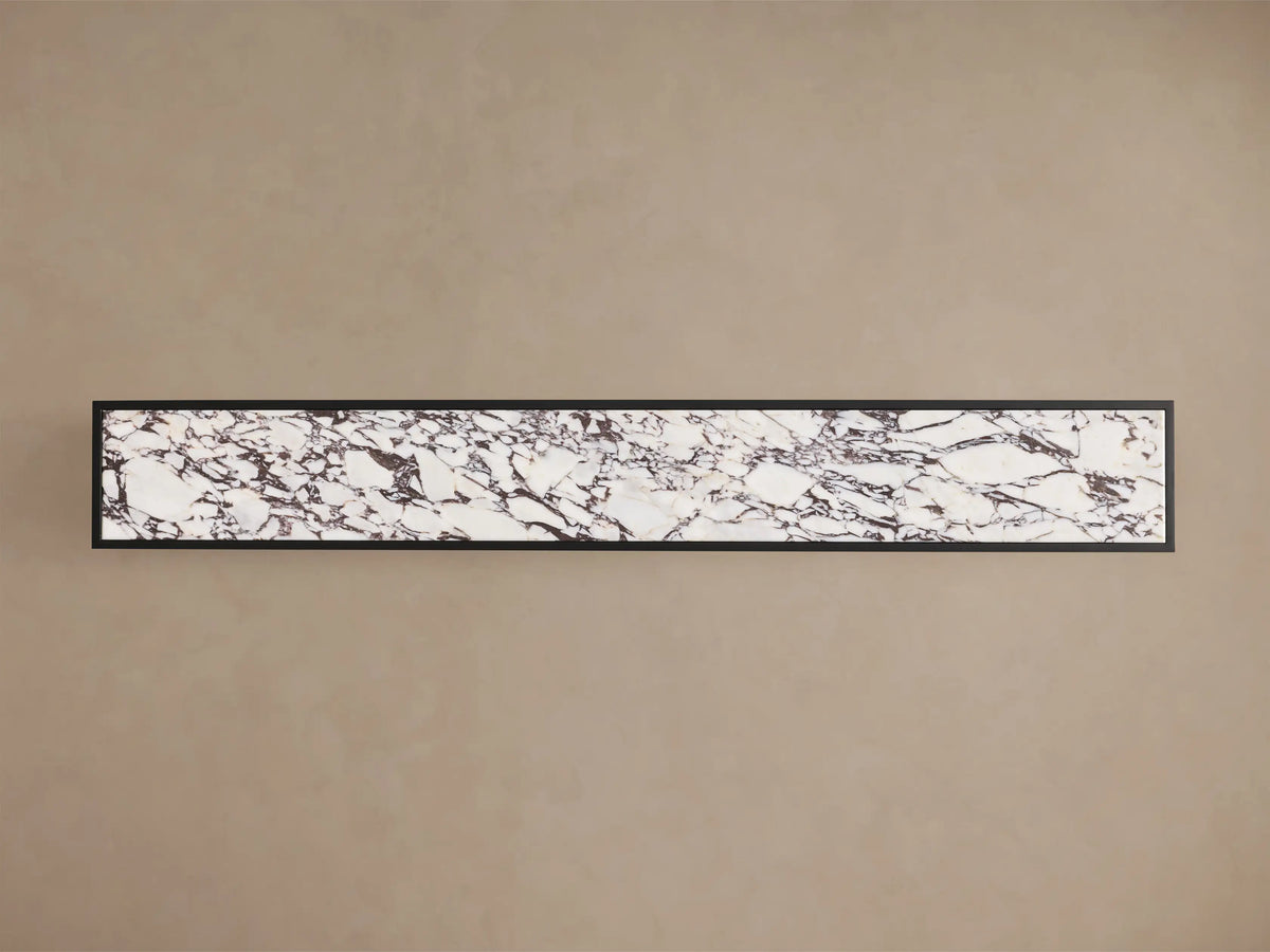 Close-up of the Mills Stone Console Table, showing the white marble top with dark veining and matte black steel frame.