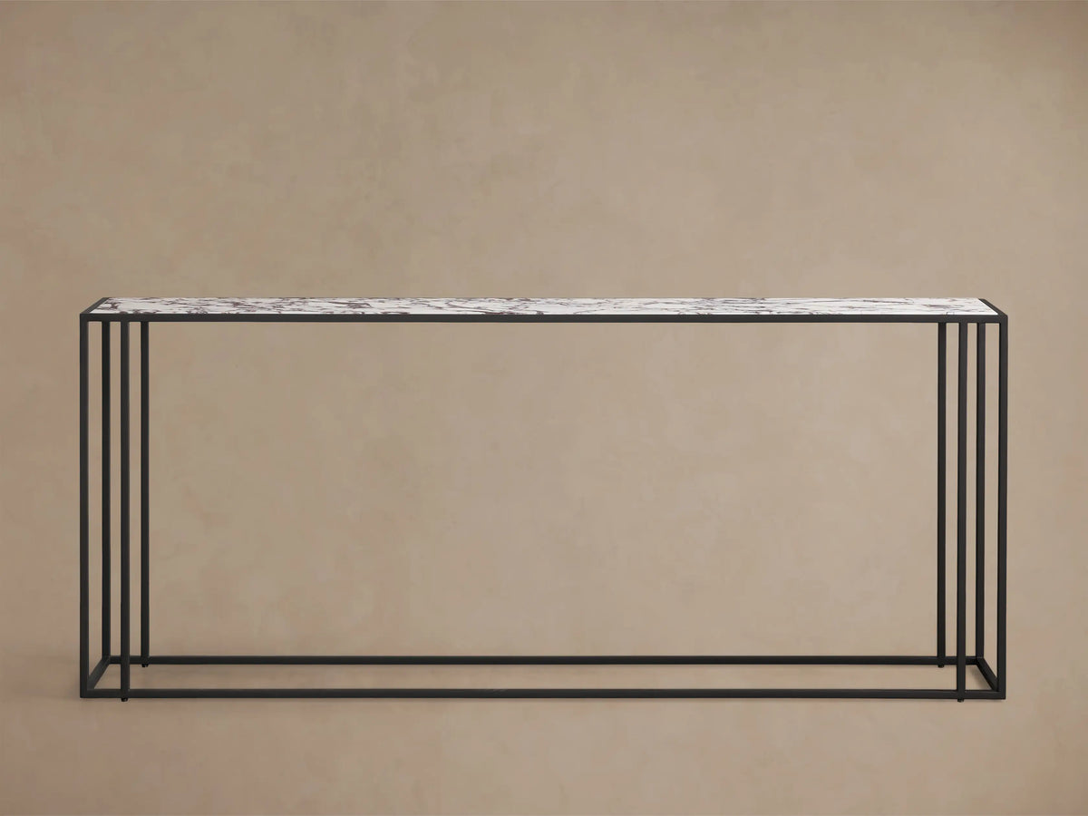 Close-up of the Mills Stone Console Table's white stone top with dark veining and a black frame.