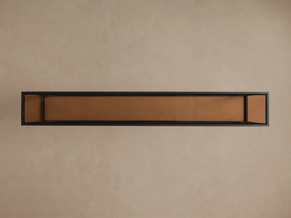 Overhead view of the Mills Glass Console Table. Long black steel frame with an antique brass-toned glass top.
