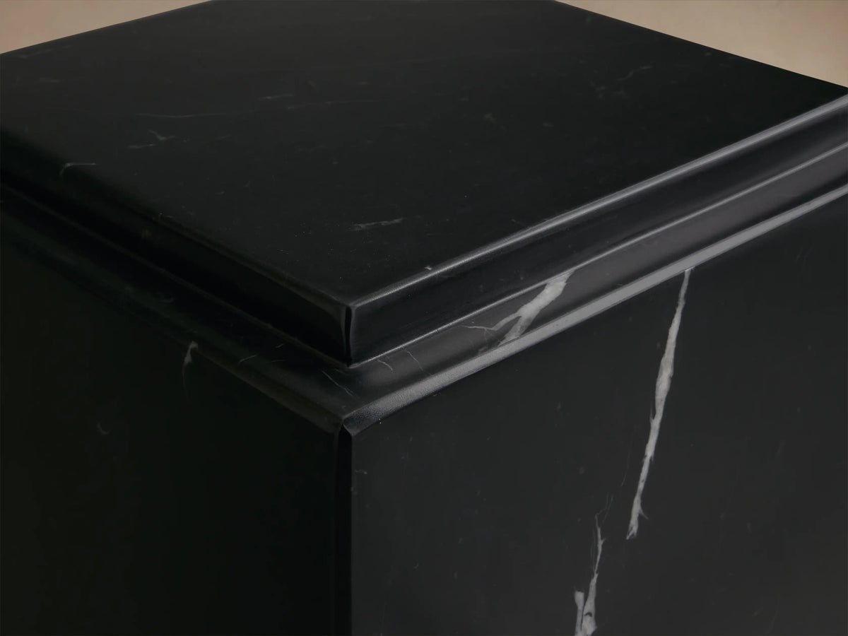 Front view of the black Marmont Pedestal, a square stone stand with white marble-like veining and a matte finish.