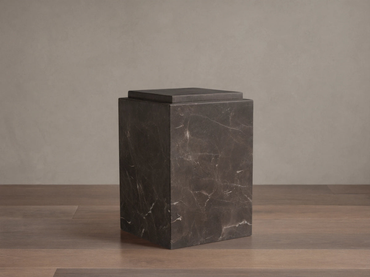 Handcrafted Marmont Pedestal made of natural dark marble with unique veining, matte lacquer finish, on a wooden floor.