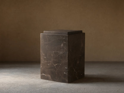 Handcrafted Marmont Pedestal made of natural dark marble with unique veining, matte lacquer finish, on a wooden floor.