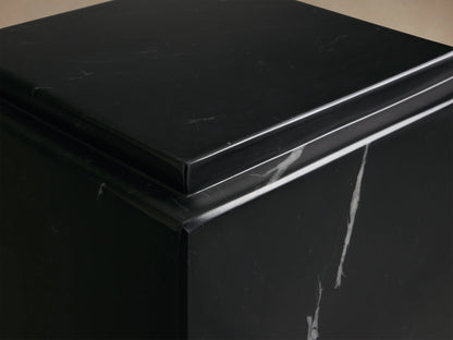 Black Marmont Pedestal crafted from natural marble, features unique white veining, matte finish, standing on wooden floor.