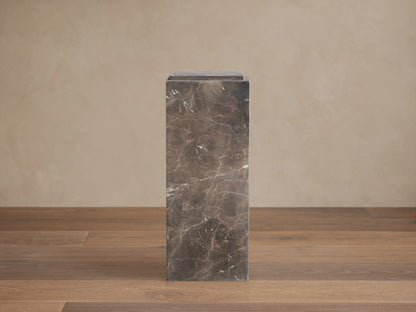 Marmont Pedestal crafted from dark marble with natural veining, rectangular shape, matte finish, on a wooden floor.