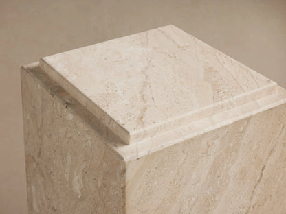 Marmont Pedestal featuring natural marble with beige veining, rectangular shape, matte finish, set on wooden floor against a neutral wall.