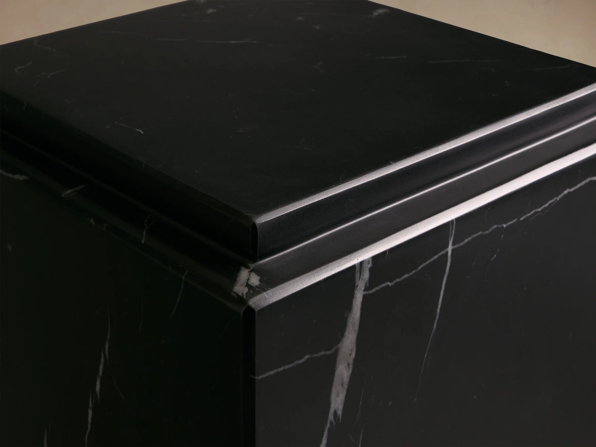 Black Marmont Pedestal with white veining, rectangular shape, smooth matte finish, on a wooden floor against a neutral wall.