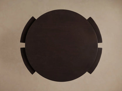 Dark, round mahogany Chiseled End Table, top-down view, showing its circular top and curved, wrap-around legs.