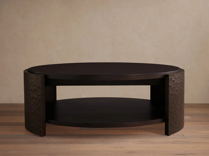 Dark mahogany chiseled round coffee table with two circular shelves and curved, textured side supports.