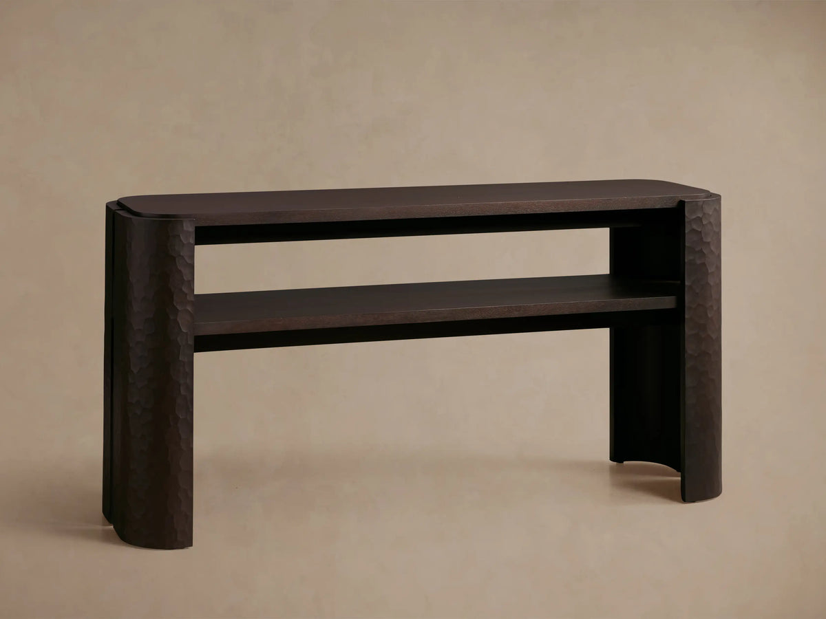 Close-up of a dark brown Chiseled Console Table corner, showing hand-carved chiseled texture on the mahogany wood leg.