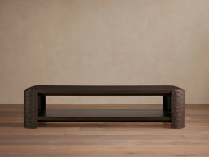 Dark mahogany Chiseled Coffee Table, two-tiered, with artisan hand-carved legs, on a wooden floor.