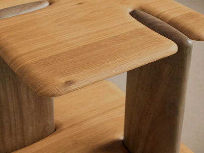Front view of a modern two-tone wooden side table. It features light wood rounded top and base platforms with dark wood vertical supports.
