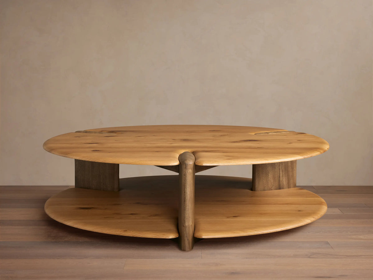 Nolito Coffee Table: Rounded, two-tier wood table with beveled edges and curved supports, showcasing two harmonious tones.