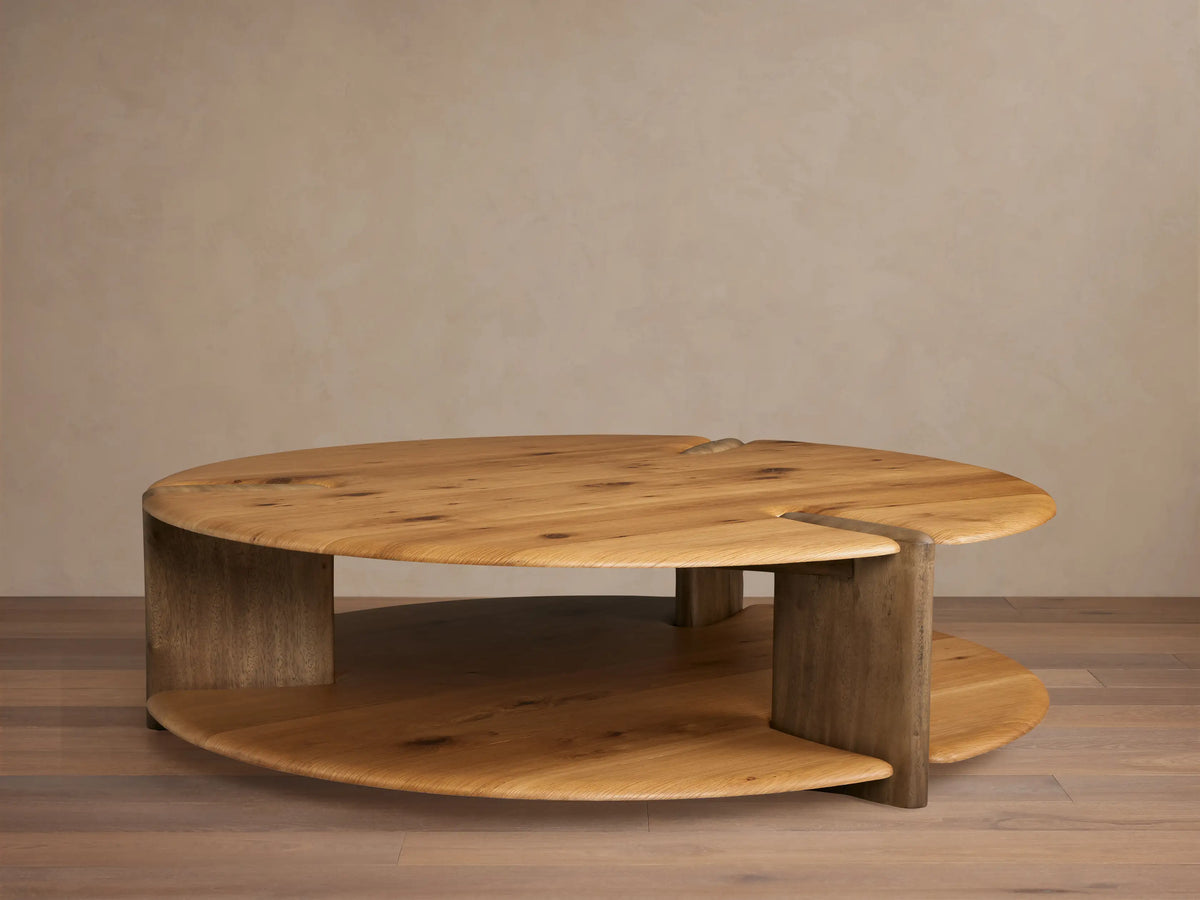Nolito Coffee Table: Rounded, two-tier wood table with beveled edges and curved supports, showcasing two harmonious tones.