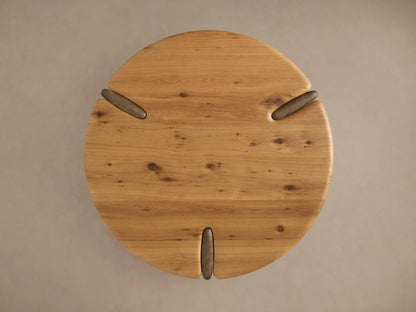 Nolito Coffee Table close-up. Rounded golden-brown wooden top & lower shelf with darker, curved support piece.