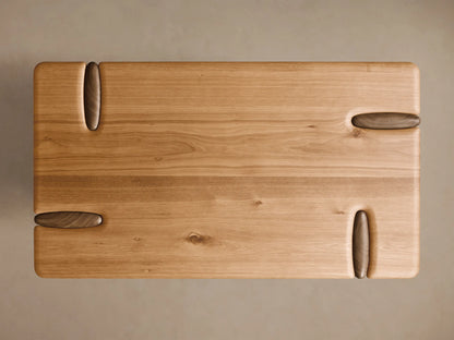 Close-up of the light brown Flowing Oak Tiered Table, showing smooth, rounded tiers and the seamless carved wood connection.