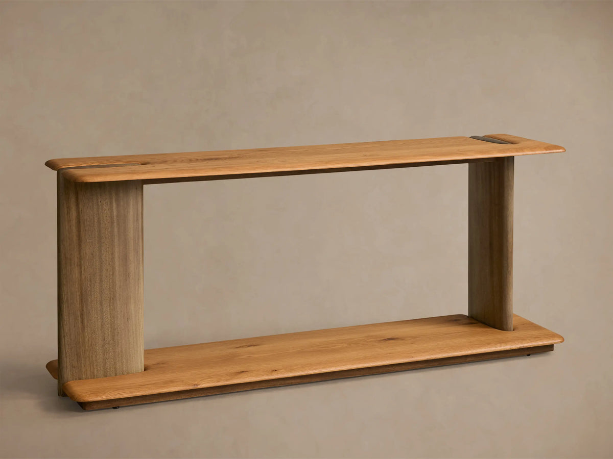 Front view of the Nolito Console Table, featuring light oak veneer shelves and darker curved guanacaste wood supports.
