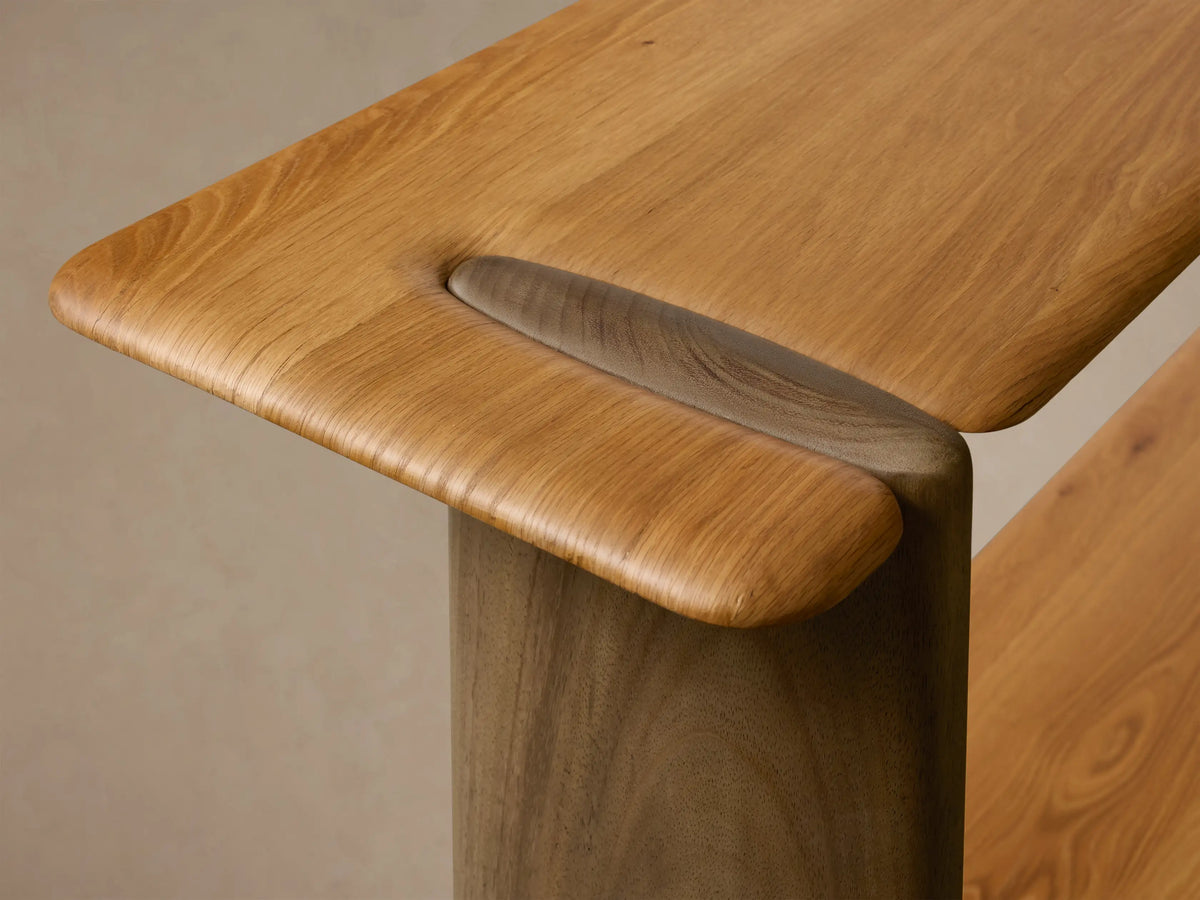 Close-up of the Nolito Console Table, highlighting its rounded silhouette, softly beveled edges, and two-tone wood construction.