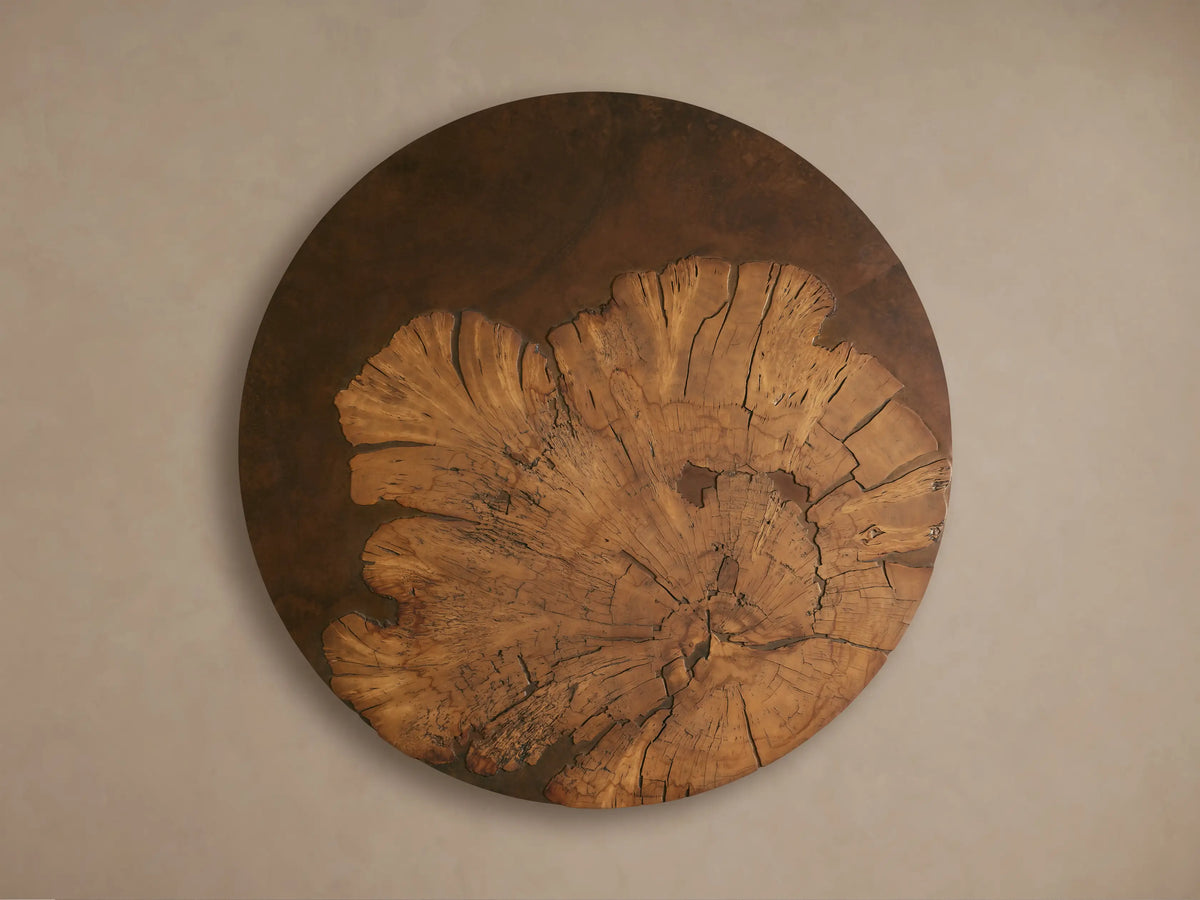 Close-up of Obra Round Coffee Table; natural milpa burl wood top with deep cracks & dark filler, wrapped around a weathered steel base.