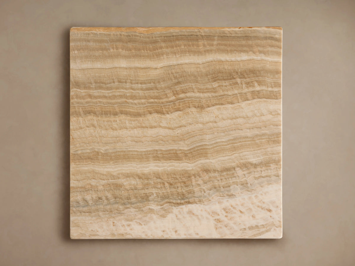 Close-up of a Grey Onyx Stool's corner. Natural wavy striations in light brown, beige, and subtle grey hues.