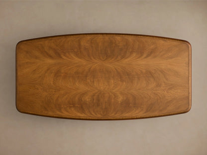 Angled view of the Palma Coffee Table, showing medium brown cerajeira wood veneer with wavy grain and dark brown trim.