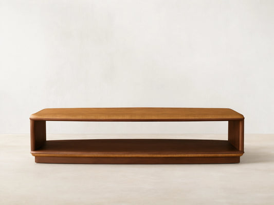 Front view of the two-tiered Palma Coffee Table with a golden brown cerajeira wood veneer top and darker mahogany base.