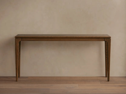 Dark ash wood Park Console Table with ebony finish, slim design. A white textured vase with flowers & books on top.