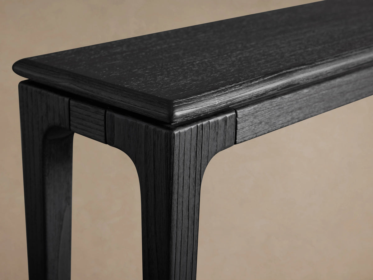 Park Console Table with ebony finish, showing a detailed close-up of its ash wood texture and sleek, smooth lines.