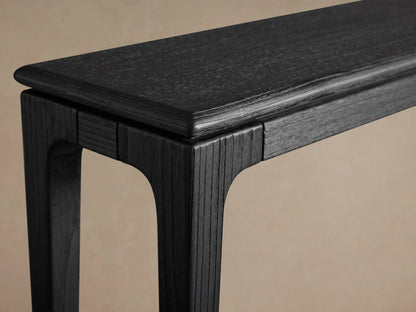 Park Console Table with ebony finish, showing a detailed close-up of its ash wood texture and sleek, smooth lines.