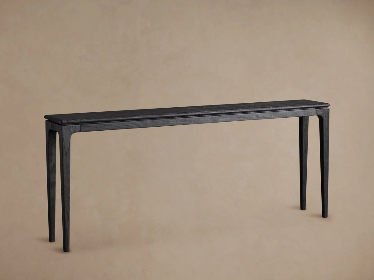 Park Console Table made of ash wood with a rich ebony finish, features sleek lines and a rectangular top, placed on wood floor.