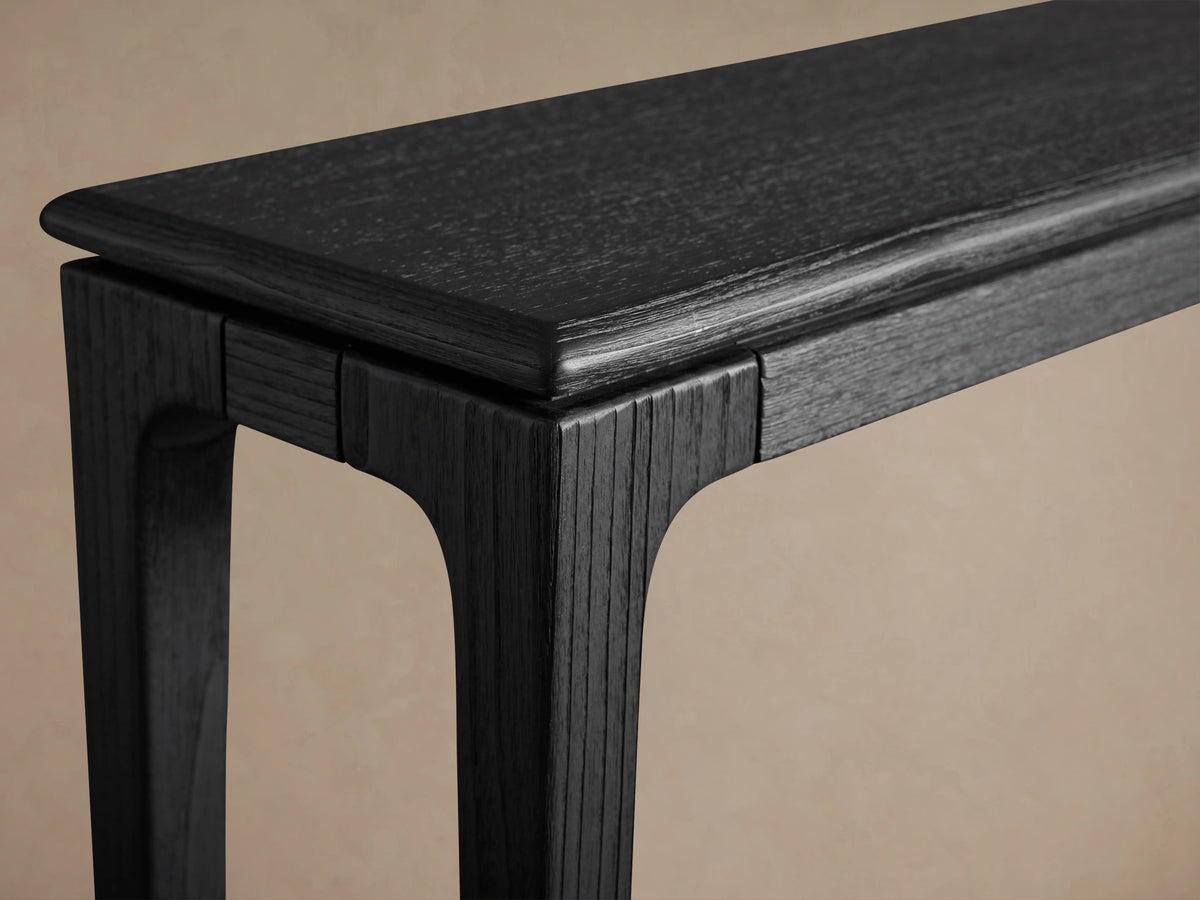 Park Console Table with an elongated rectangular shape, crafted from ash wood, featuring an ebony finish and four slender legs.