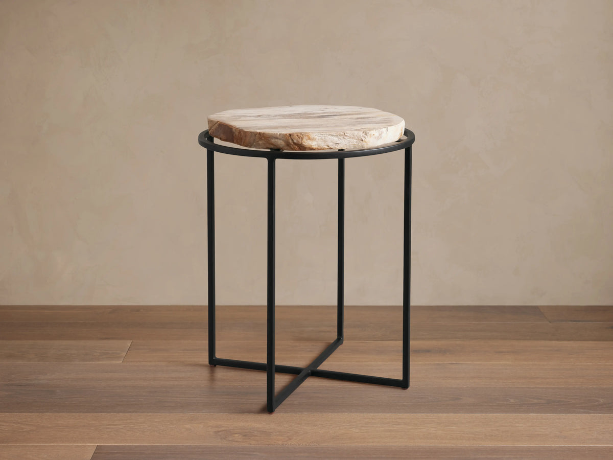 Front view of the Wood Slice Side Table, featuring a round, natural-edge wood slice top and a black metal cross-base.