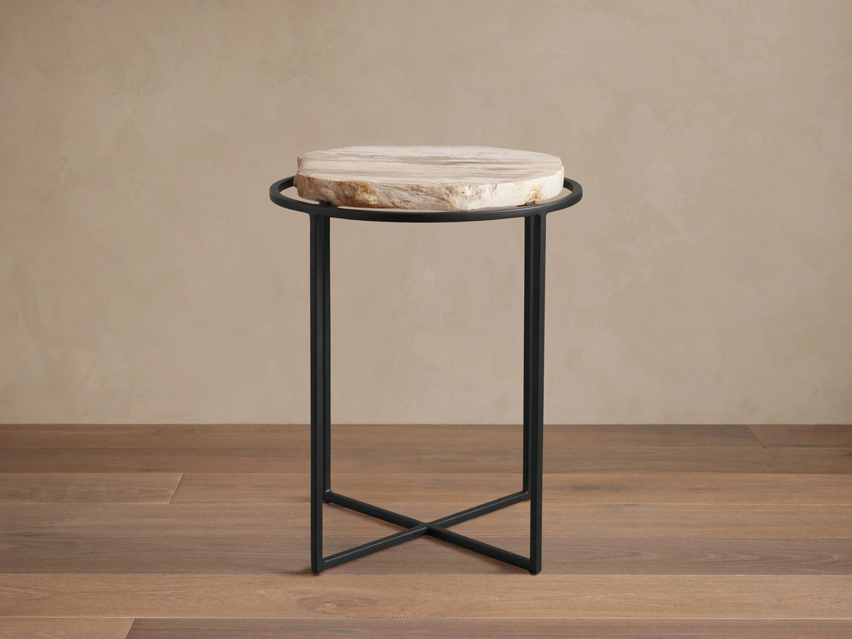 Front view of the Wood Slice Side Table, featuring a round, natural-edge wood slice top and a black metal cross-base.