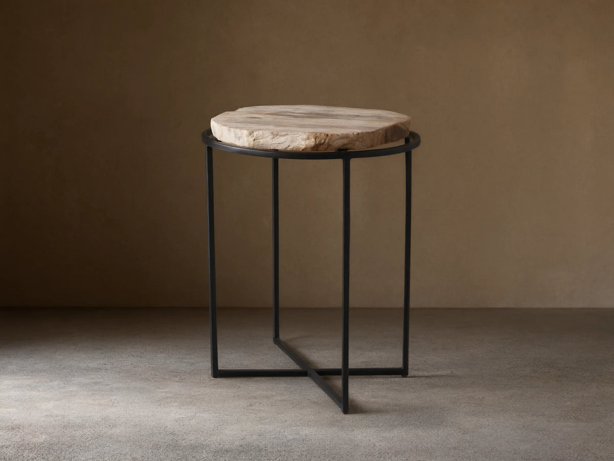 Front view of the Wood Slice Side Table, featuring a round, natural-edge wood slice top and a black metal cross-base.