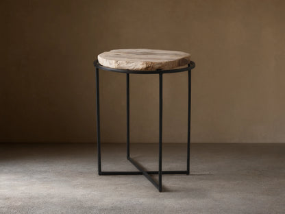 Front view of the Wood Slice Side Table, featuring a round, natural-edge wood slice top and a black metal cross-base.