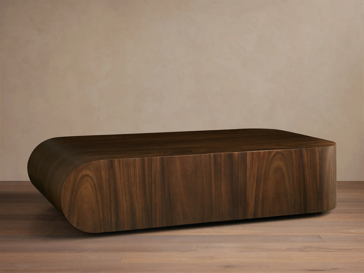 Front view of a dark brown wooden coffee table, low-profile and oblong with smooth, rounded edges.