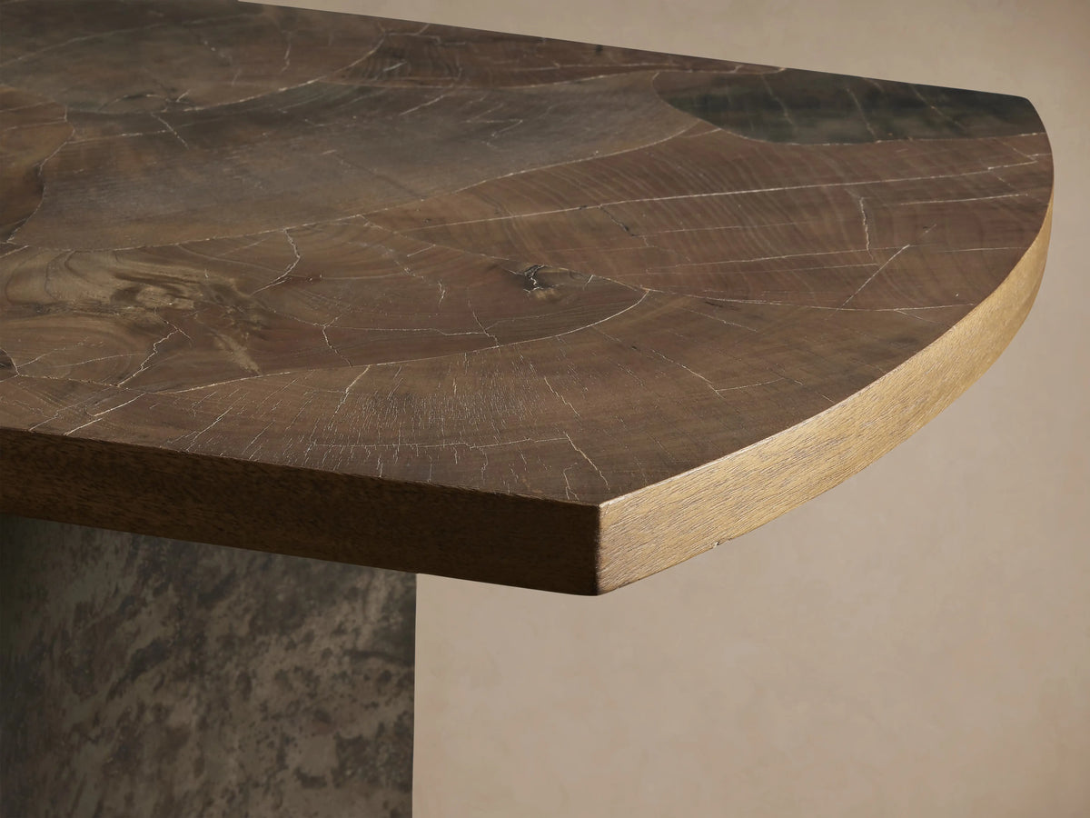 Polanco Console Table with a rounded edge, showcasing rich wood grain, natural cracks, and a smooth lacquered finish.