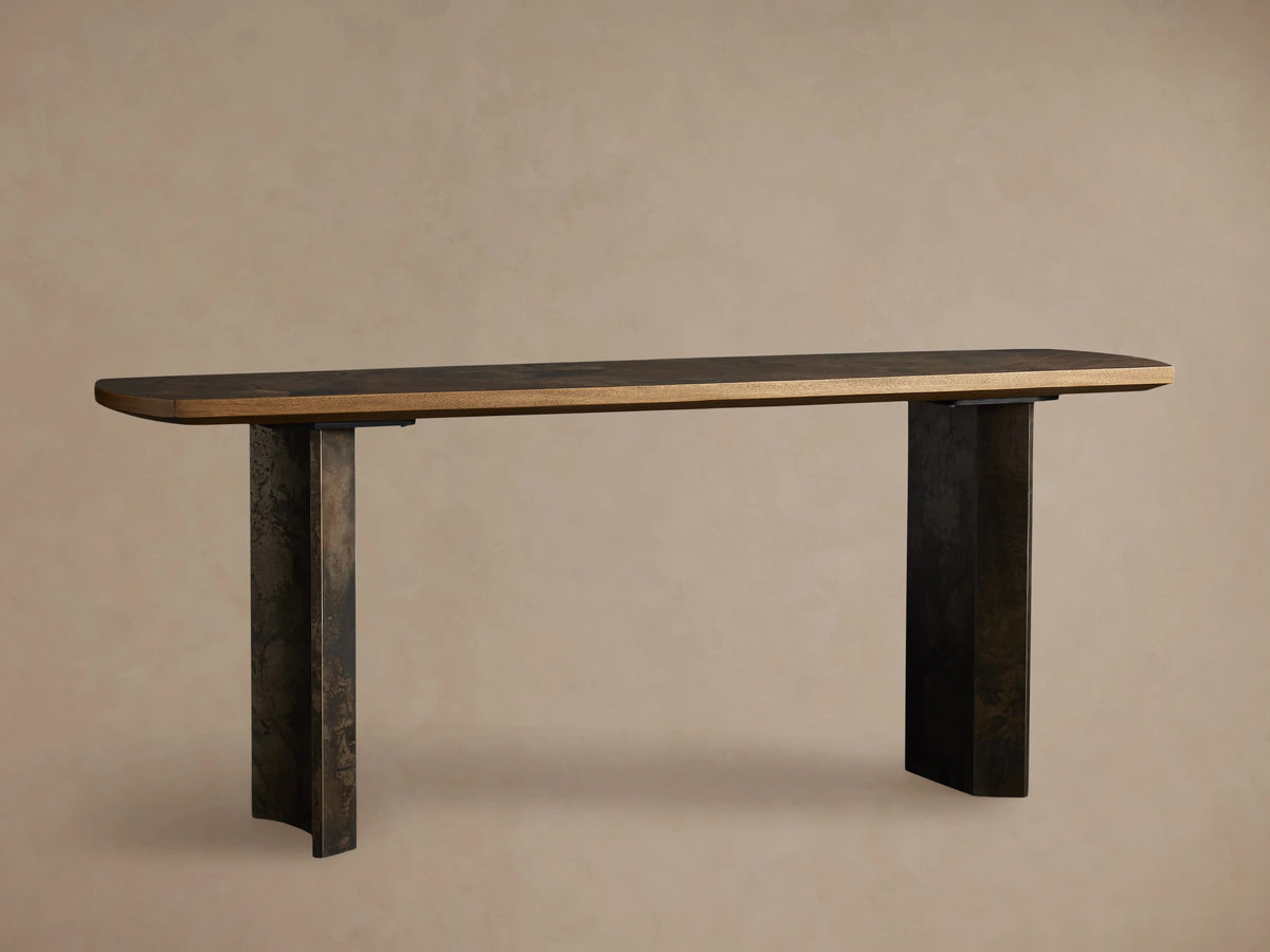 Polanco Console Table with a dark wooden top and two slightly textured steel legs, shown against a neutral background.