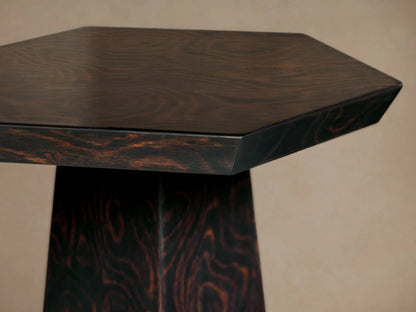 Redge Hexagonal Martini Table, close-up angled view of the dark brown hexagonal top with subtle grain, and the base with swirling madrona burl.