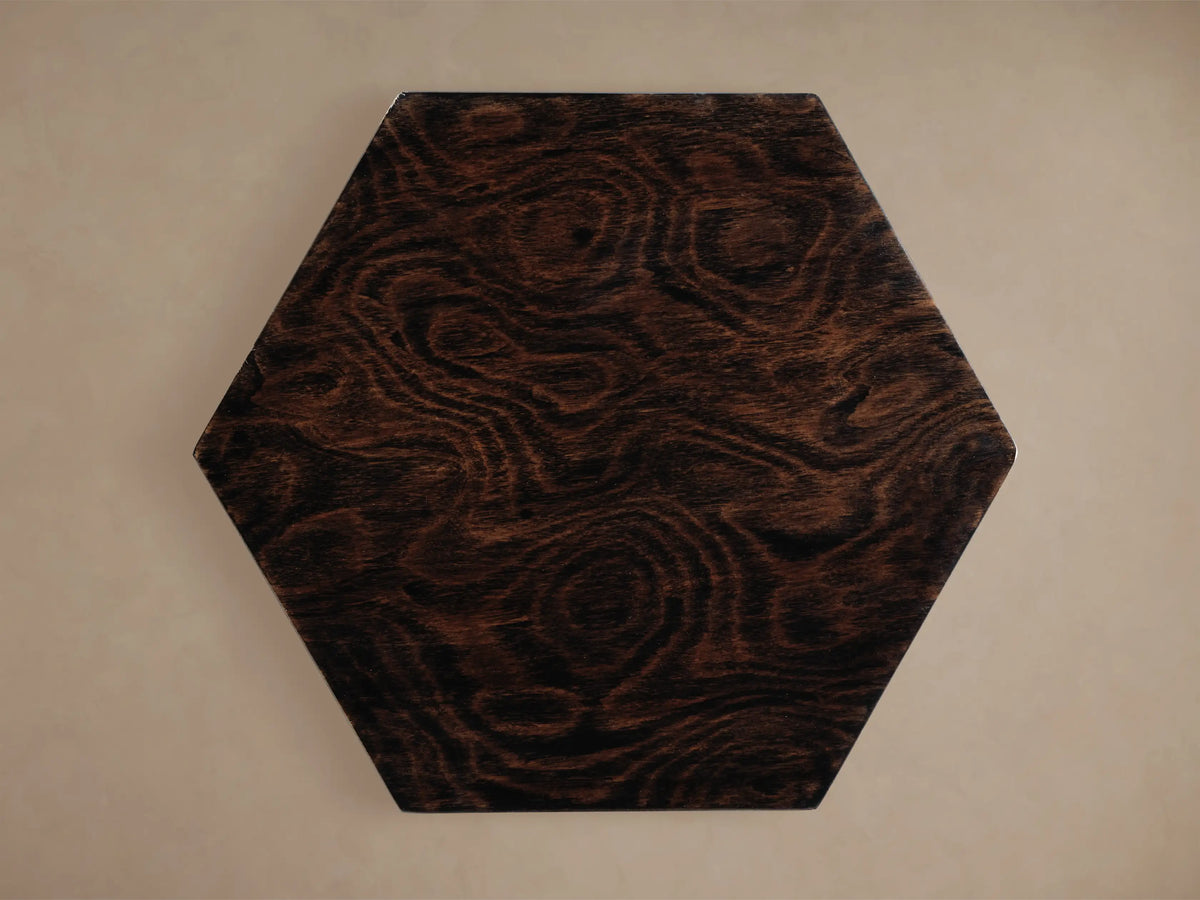 Dark brown Redge Hexagonal Martini Table top, madrona burl veneer with swirling grain, viewed from above on a light background.