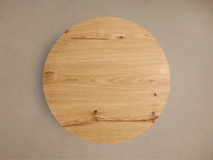 Front view of the natural white oak Redding End Table, featuring a round top and lower shelf supported by curved, thick legs.