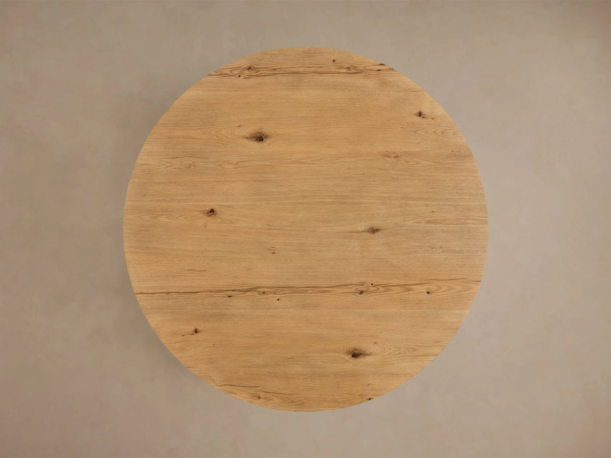 Top-down view of the light oak Redding Round Coffee Table, featuring natural wood grain and knot details.