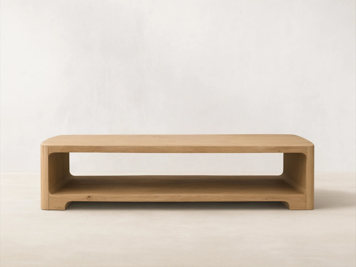 Front view of a light wood Redding Coffee Table, featuring rounded edges and a built-in lower shelf.